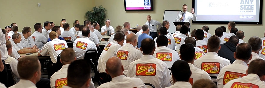 Room full of employees watching training presentation