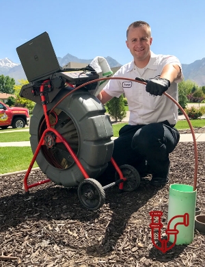 Plumber holding line for drain cleaning outdoors